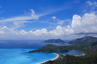 bird's eye view of islands near under blue sky