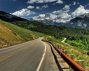 concrete road near mountain at daytime HD wallpaper