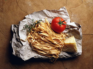 pasta, cheese, and tomato on white textile