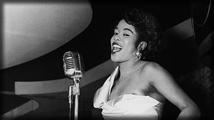 greyscale photo of woman singing