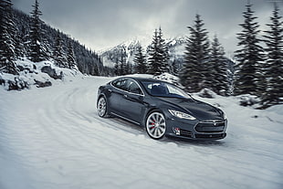 black car on snow filled road at daytime