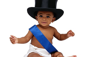 baby wearing black top hat and blue sash