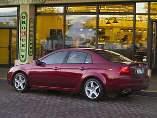 red Acura TL parked on gray top raod HD wallpaper