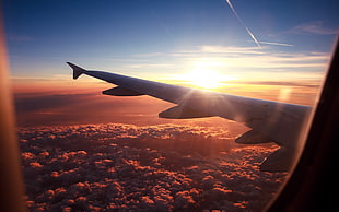 clear glass airplane window showing sunset with cloudy sky HD wallpaper