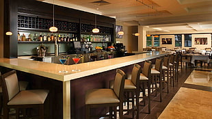 rectangular brown wooden table with chairs, bar