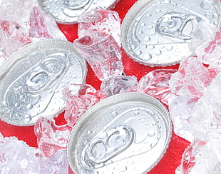 three red-and-gray beverage cans