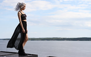 photo of woman standing on dock