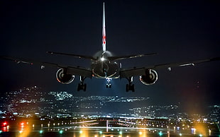 passenger plane getting ready on runway to land at night time HD wallpaper