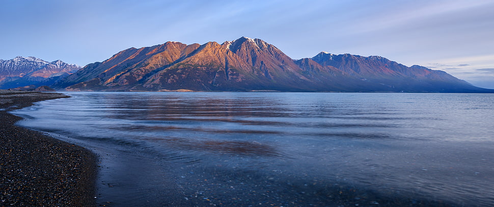 landscape photography of mountain range near calm body of water HD wallpaper