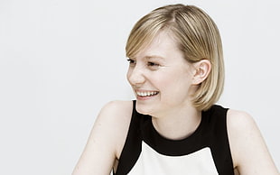 woman in black and white sleeveless top with white background