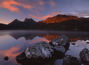 brown mountain under red and blue skies near body of water, cradle mountain