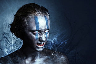 woman with blue and gray paint on face