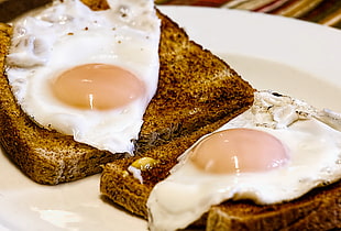 brown bread with eggs served on white ceramic plate