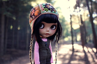 black haired girl with multicolored floral aviator knit hat