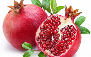 red Pomegranate fruit sliced and whole