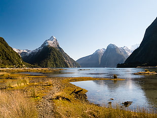 rippling body of lake water over looking mountains, mitre peak