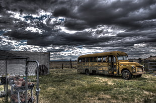 photography of school bus near fence