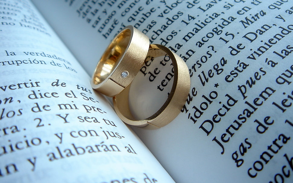 two gold rings on book HD wallpaper