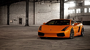 orange Lamborghini Gallardo parked inside the warehouse