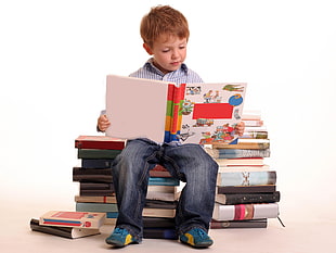 boy holding and reading books