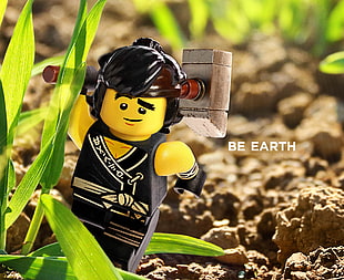 shallow focus photography of black haired boy holding hammer minifig