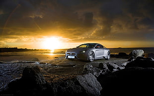 silver coupe parked ahead on rock formation during golden hour HD wallpaper