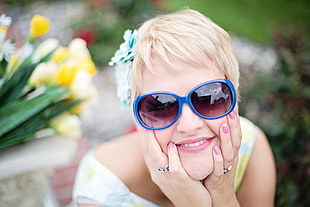 photo of woman wearing blue oversize sunglasses