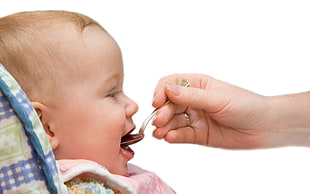 photo of person feeding baby