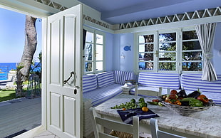 white wooden 4-paneled door open beside rectangular faux table