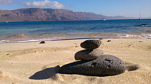 three gray pebbles, beach, stones, Lanzarote HD wallpaper