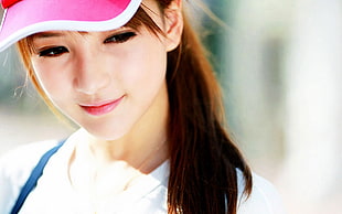 girl wearing pink and white cap