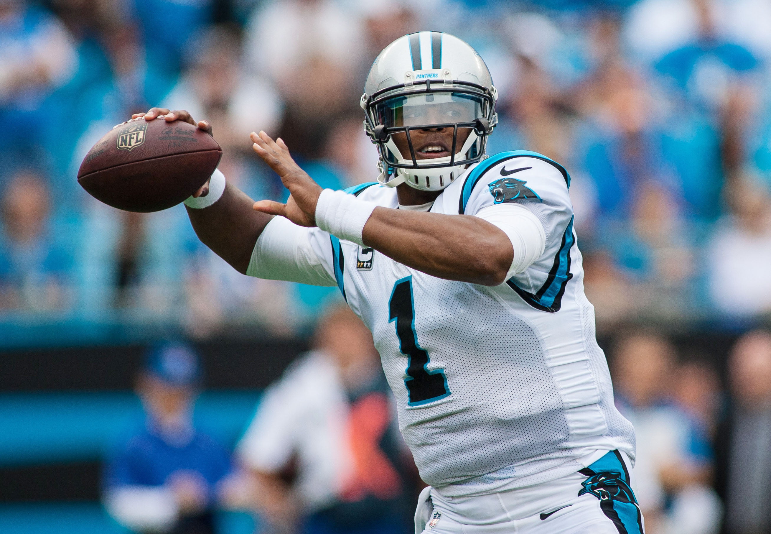 football player throwing NFL football