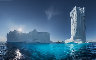 two giant ice bergs on a body of water