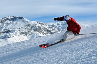 man wearing red-and-white bubble jacket and pants while on snow HD wallpaper