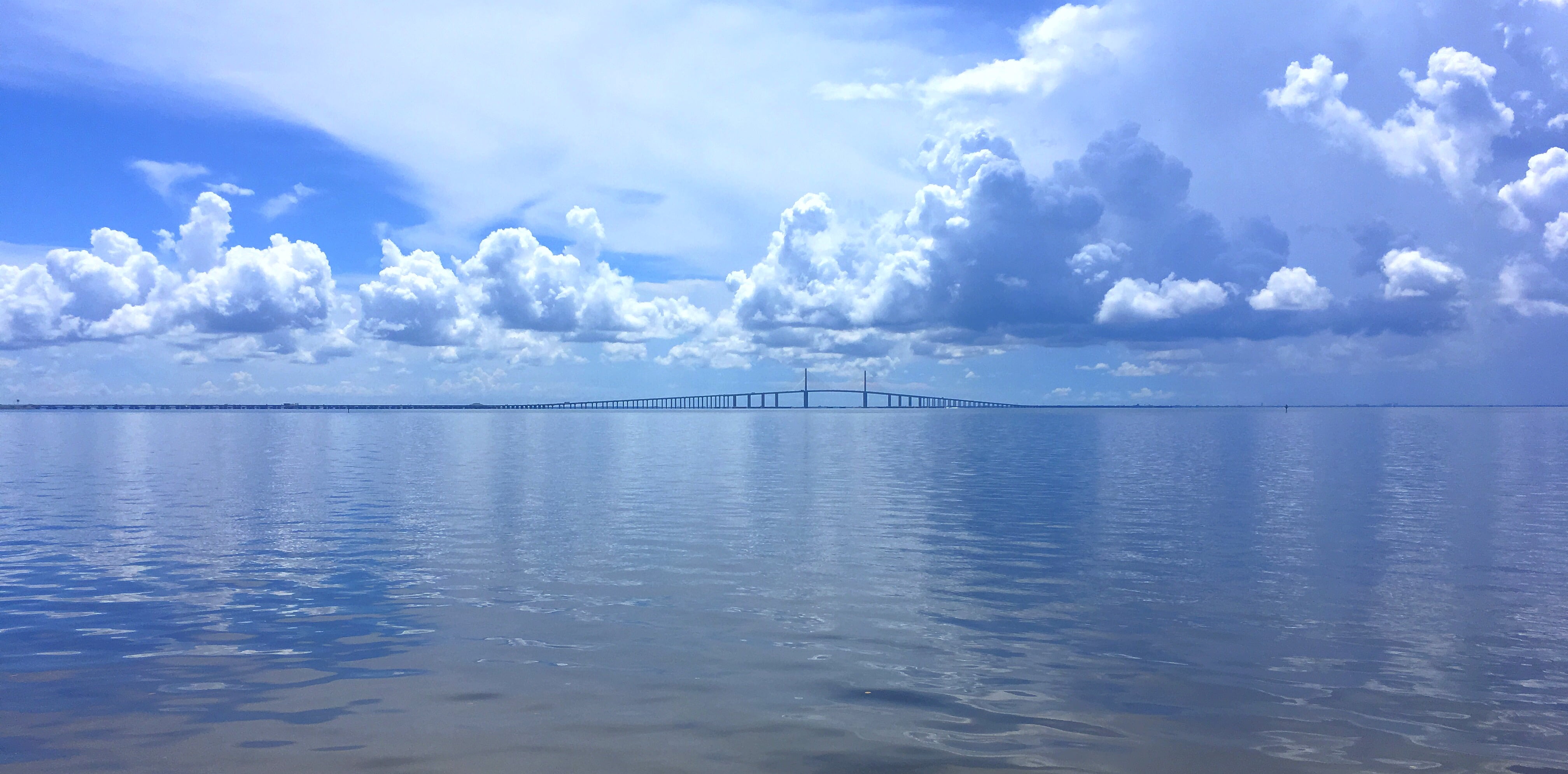 blue sea under white and blue sky picture during daytime