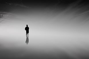 silhouette of person surrounded by fogs