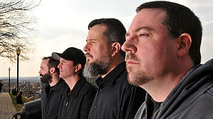 four man wearing black jackets
