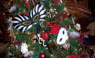 green and multicolored Christmas tree with masquerade masks