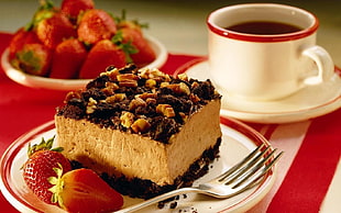 chocolate cake with peanut and strawberry on plate