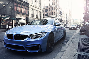 blue BMW coupe at city street during daytime
