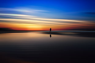 silhouette photography of person standing on seashore, landscape, sunset, sky, reflection
