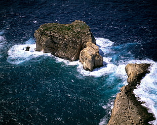 aerial view photography of rock formation on ocean