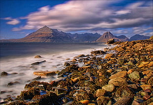 landscape photography of rock near body of water under nimbus clouds, elgol HD wallpaper