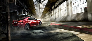 red coupe running inside warehouse during daytime HD wallpaper