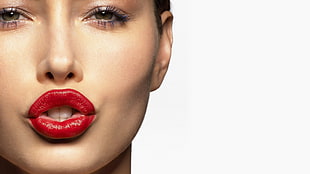 Woman pouting lips with red lipstick