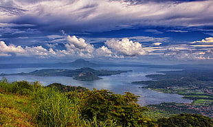 green trees surrounded by body of water under cloudy sky, taal lake, tagaytay, philippines HD wallpaper