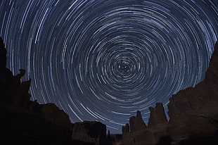 time lapse photography of brown rock formation under clear starry night during nighttime, arches national park, utah