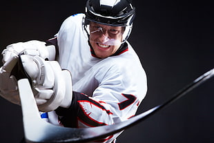 ice hockey player in white and black jersey and black helmet