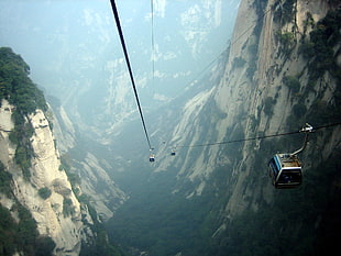 cable cars between hills during daytime