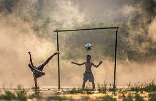two boys playing soccer HD wallpaper